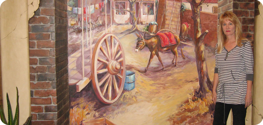 Artist Karen Wall and a hand painted mural
