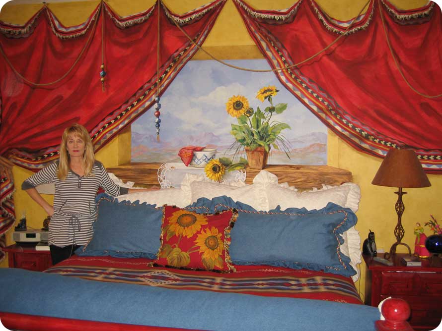 Artist Karen Wall and one of her hand painted murals